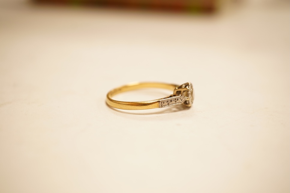 A modern yellow metal and single stone diamond set ring, with baguette and round cut diamond cluster set shoulders, total diamond weight approx. 0.50ct, size J/K (sizing spheres), gross weight 4.6 grams.